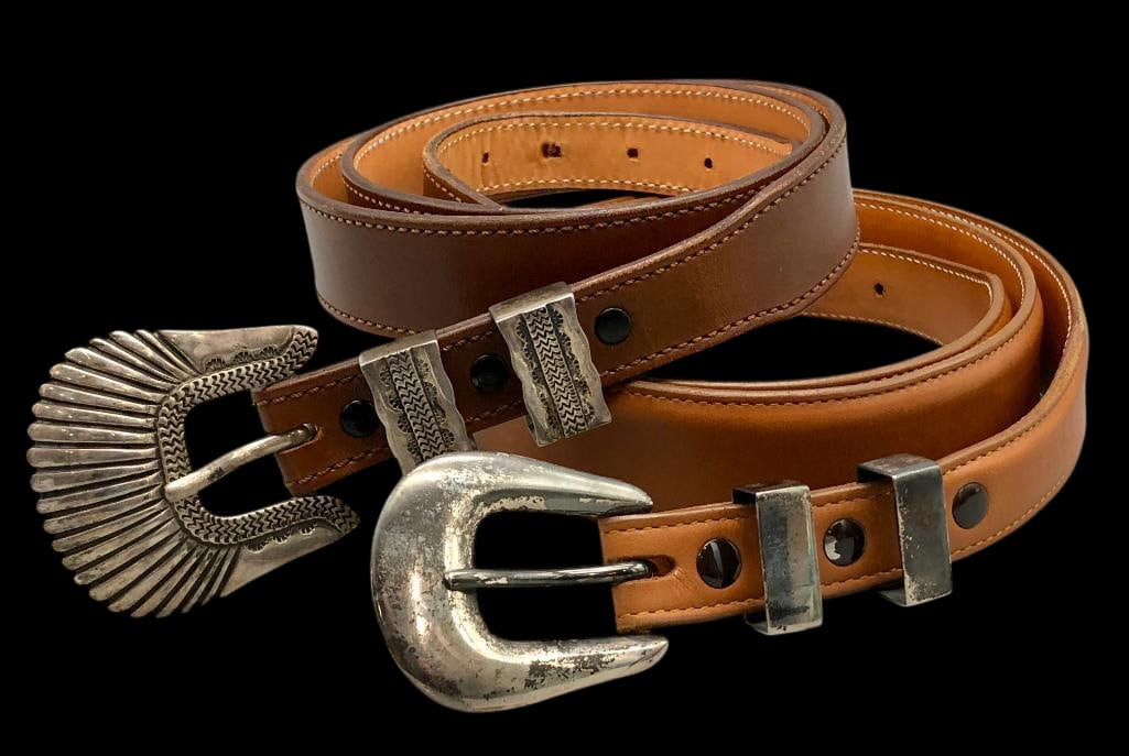 Two James Reid Sterling Silver Ranger Sets With Belts: Offered here for your consideration are two James Reid sterling silver ranger sets with belts. Each set includes a sterling silver buckle, two keepers and tip displayed on brown leather belts. One set