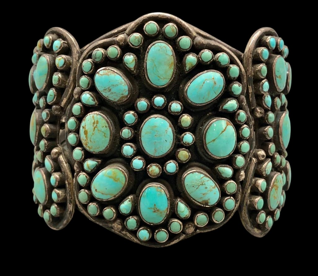 Hefty Vintage Sterling Silver And Turquoise Cluster Bracelet: Offered here for your consideration is a hefty vintage sterling silver and turquoise cluster bracelet. This bracelet features turquoise cabochons set in smooth silver bezels arranged in an elaborate c