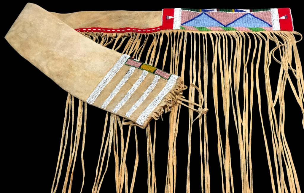 Crow Buckskin Beaded Rifle Case: Offered here for your consideration is a Crow buckskin beaded rifle case. This rifle case features multicolored, intricate beadwork on a softened brain tanned leather hide, accented with long fringe.