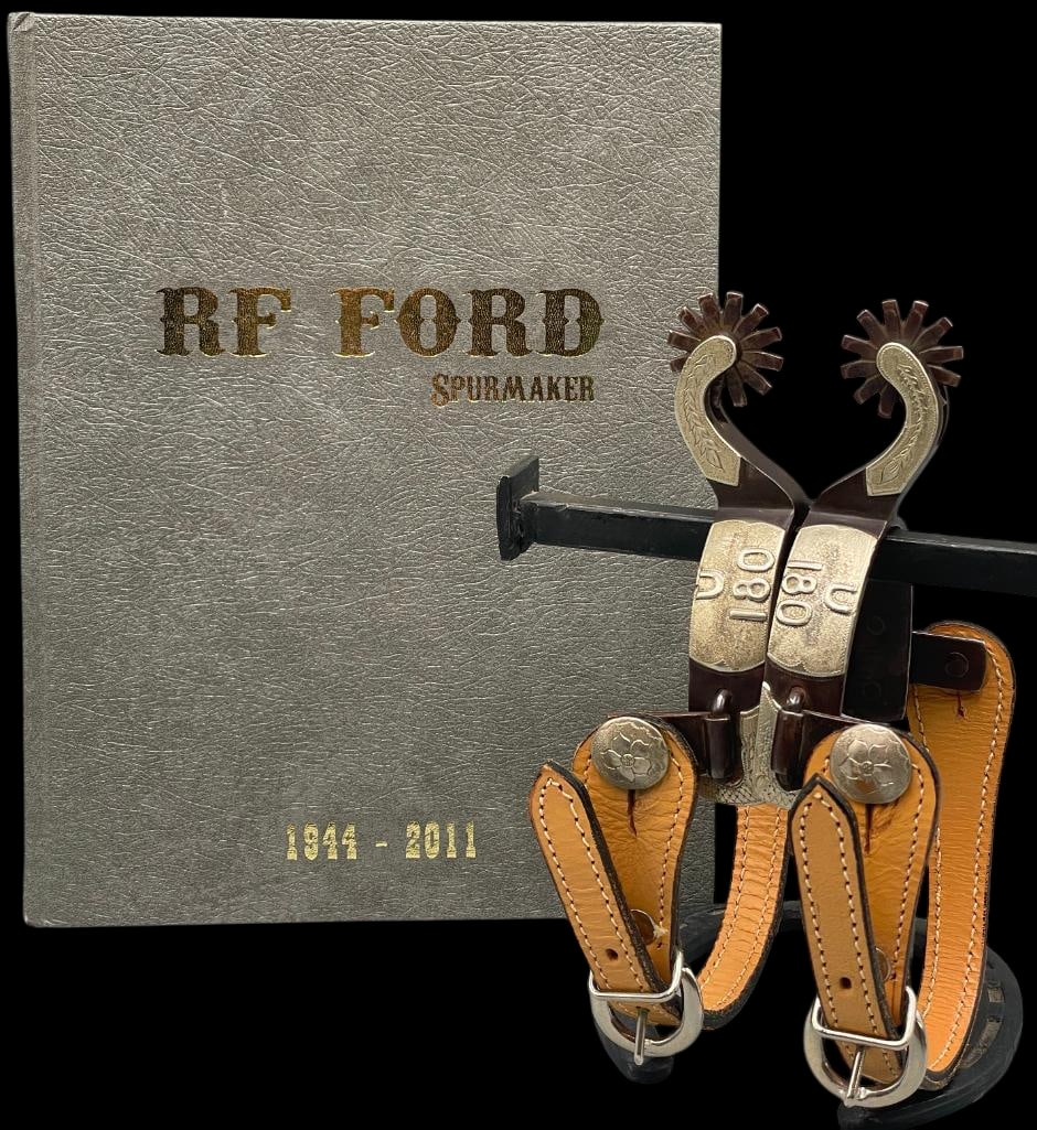 RF Ford Spurs #583 With Signed RF Ford Spur Maker Book: Offered here for your consideration is a pair of blued, engraved and silver mounted spurs by RF Ford, complete with a signed RF Ford Spurmaker book. The spurs display a blued steel finish with decorat