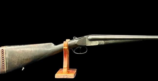 Antique Side By Side Engraved 12 Gauge Shotgun: For your bidding pleasure is a antique side-by-side engraved 12 gauge shotgun. This firearm has a blued barrel set, double trigger and a hardwood stock fitted with a White-Line recoil pad marked “Wh
