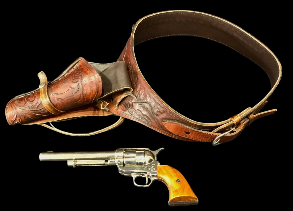 Prop Gun And Single Rig Holster: For your bidding pleasure is a single action style prop gun and single rig holster. The faux revolver has a nickel-colored finish and wood pattern grips. The leather rig shows classic Western style to