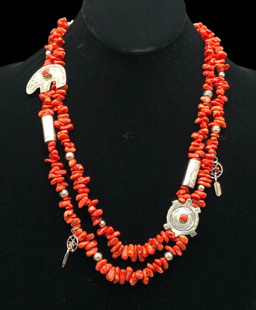 Coral And Sterling Silver Treasure Necklace: Available here for your consideration is a coral and sterling silver treasure necklace. This necklace features two strands of coral beads accented with sterling silver charms throughout. The silver wo