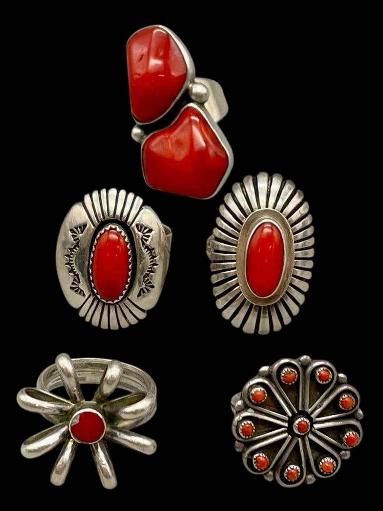 Five Turquoise And Sterling Silver Rings: Offered here for your consideration are five coral and sterling silver rings. The pieces feature one or multiple coral cabochons set in silver bezels. Accenting the stones are silver arches, dots, han