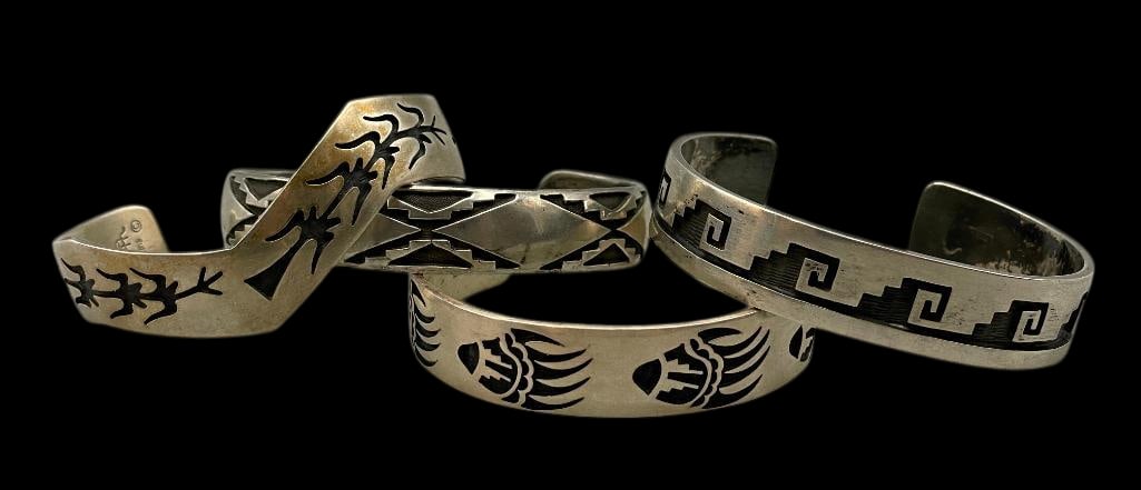 Four Sterling Silver Overlay Style Bracelets: For your bidding pleasure are four sterling silver overlay style bracelets. Three of the pieces have a smooth cuff finish, while the fourth features an intricately shaped cuff. Each is accented with a