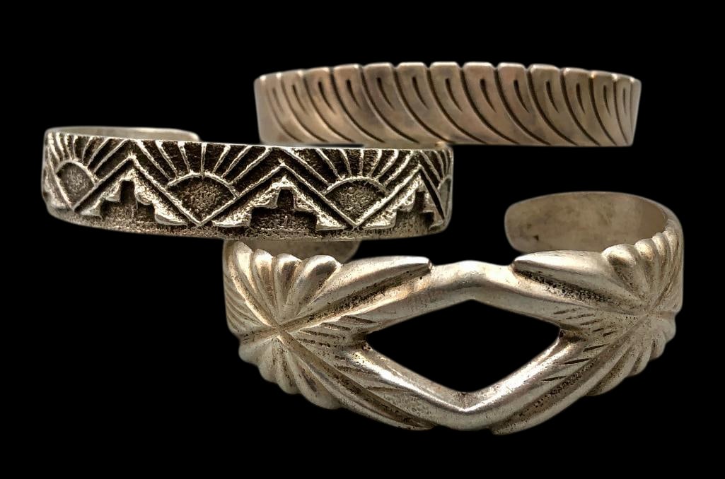 Three Sterling Silver Cast Bracelets: Offered here for your consideration are three sterling silver cast bracelets. Each bracelet offers a different design, ranging from tufa cast and sandcast pieces to a hand stamped smooth silver cuff.