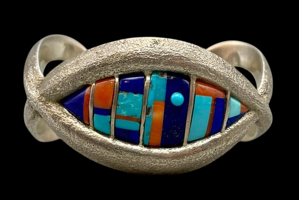 Philander Begay Multi Stone Inlay Tufa Cast Bracelet: Offered here for your consideration is a Philander Begay multi stone inlay tufa cast cuff bracelet. This intricately shaped tufa cast cuff features a central eye shaped multi stone channel inlay of tu