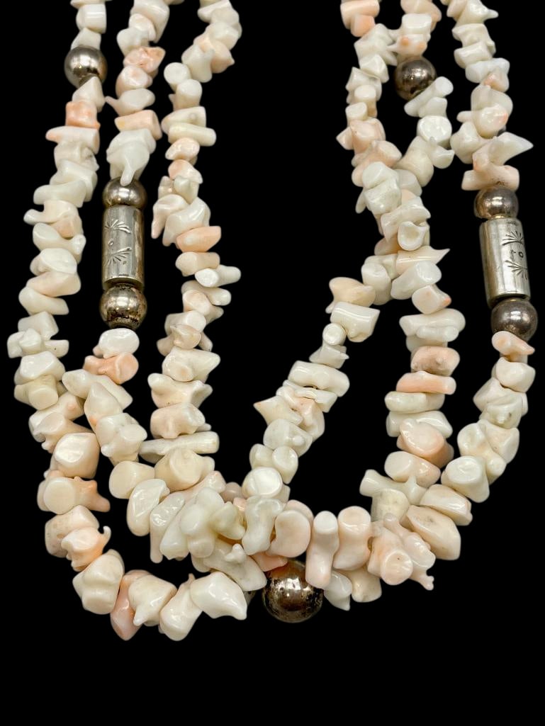 Peach Coral And Sterling Silver Necklace: Offered here for your consideration is a peach coral and sterling silver necklace. This necklace features three strands of peach coral beads accented with round and cylindrical sterling silver beads t