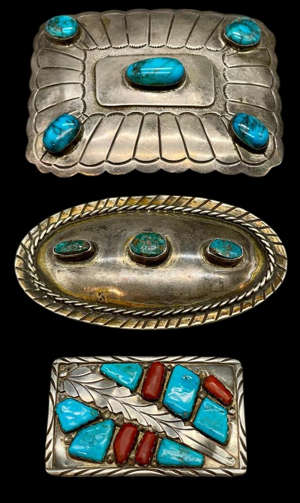 Three Sterling Silver Buckles Featuring Turquoise - One With Coral: Available here in this lot are three sterling silver buckles featuring turquoise - one with coral. One buckle features turquoise and coral cabochons set in silver bezels, while the other two showcase
