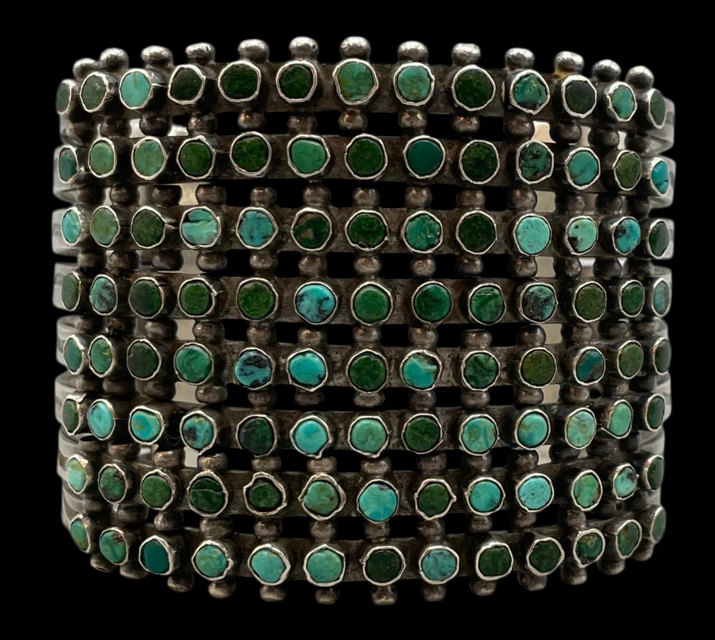 Zuni Eight Row Sterling Silver And Snake Eye Turquoise Bracelet: Presented here for your consideration is a Zuni eight row sterling silver snake eye turquoise bracelet. The bracelet features turquoise snake eye stones set in smooth silver bezels. Accenting the