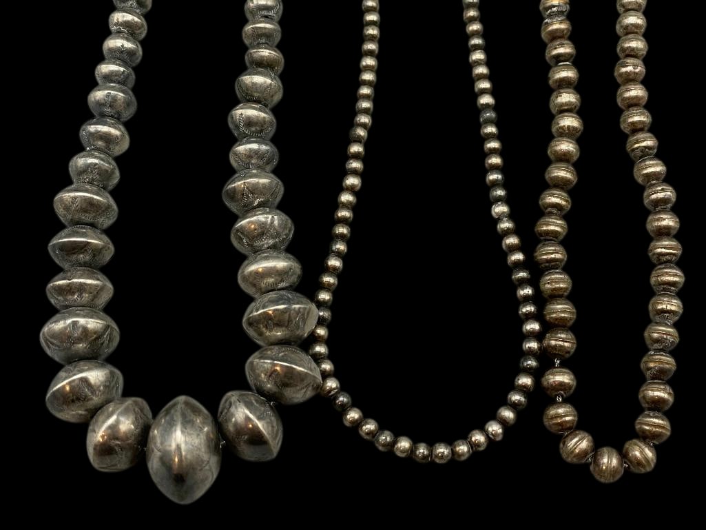 Three Sterling Silver Beaded Necklaces - One Graduated Stamped Beads: Offered here for your consideration is a group of three sterling silver beaded necklaces. Each piece features a strand of round sterling silver beads. One of the necklaces is further accented with