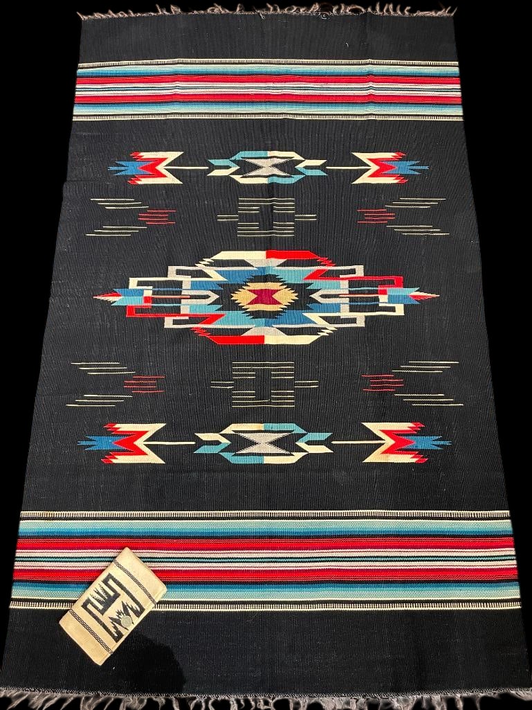 Vintage Chimayo Blanket And Purse.: Available here for your consideration is a vintage Chimayo blanket and purse. The blanket features geometric patterns of red, white and blue set on a black background with tied off warps at the ends.