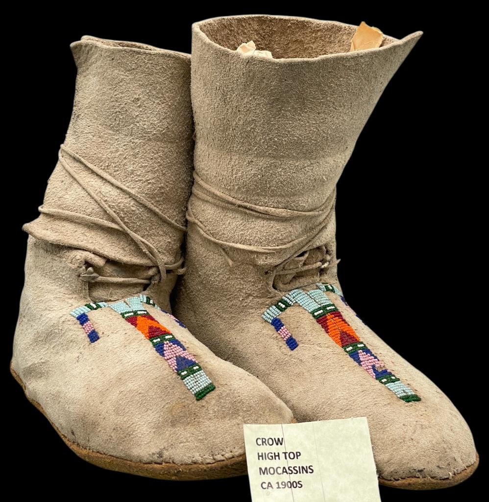 Antique Crow Beaded Hightop Moccasins: Offered here for your consideration is a pair of antique Crow beaded Hightop moccasins. These moccasins feature seed beadwork done in colors of green, blue, pink and others. The beads are sewn on