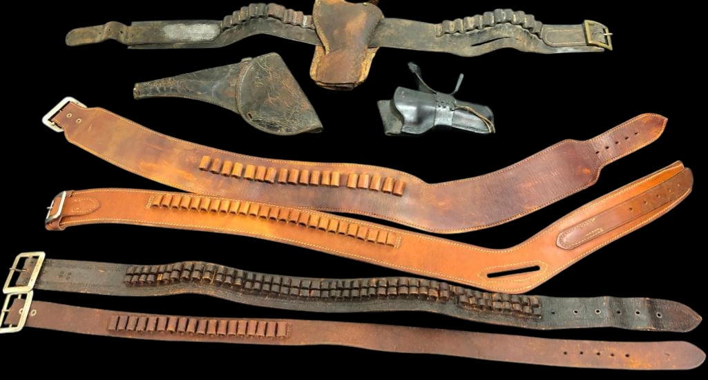 Group Of Vintage And Antique Gun Leathers: Offered here for your consideration is a group of vintage and antique gun leathers. This group features four leather belts, one with rigging, and two single leather holsters. The belts all contain