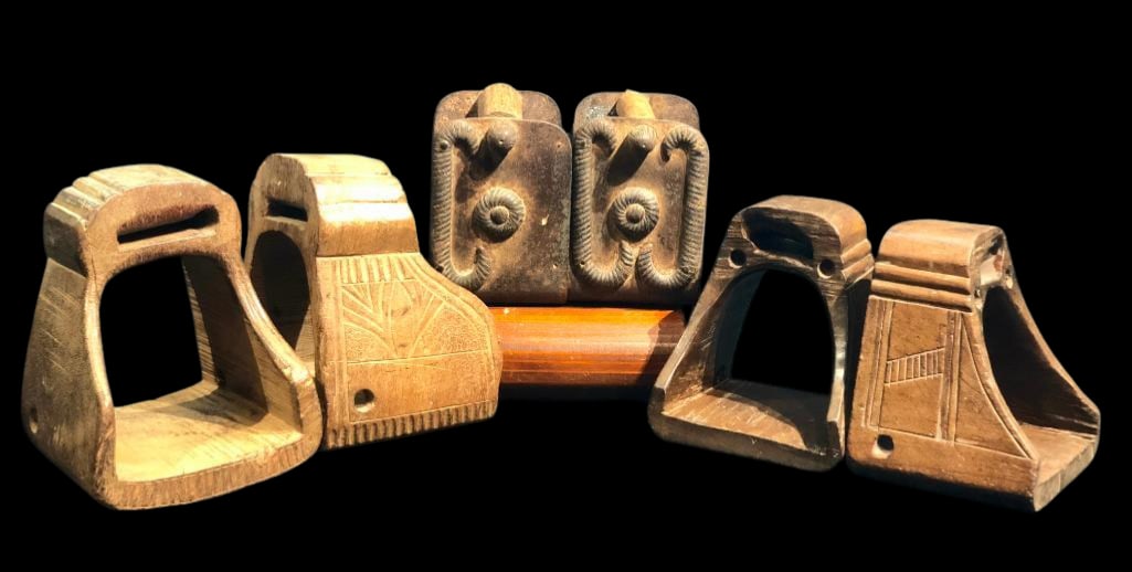 Group Of Three Antique Spanish Colonial Era Stirrups: Presented for your consideration are three sets of antique Spanish Colonial era riding stirrups. Two are hand carved thick wood with detailed designs. The other pair is made of hand forged steel and
