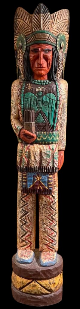 Cigar Store Wooden Indian By Frank Gallagher Circa 1980s: Offered here for your consideration is a cigar store wooden Indian by Frank Gallagher, circa 1980s. This carved wooden figure is hand painted and stands on a carved base. The figure is shown with a fe