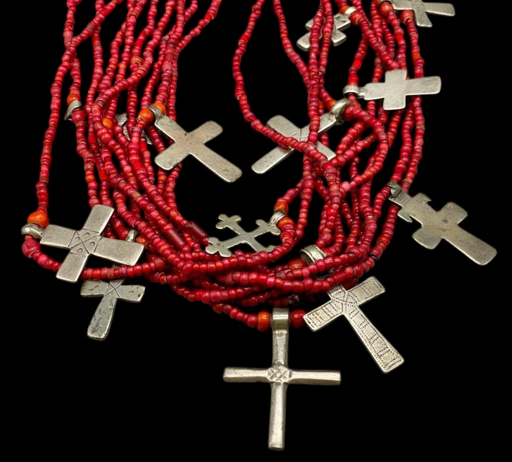 Circa 1950s Trade Bead Necklace With Crosses: Offered here for your consideration is a circa 1950s trade bead necklace with crosses. This necklace features 10 strands of red white heart trade beads accented with 12 sterling silver cross pendants