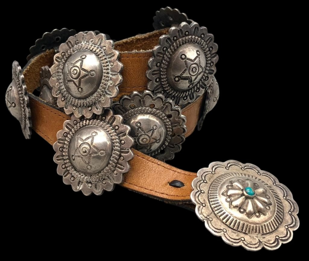 Circa 1930s-1940s Sterling Silver Concho Belt: Offered here for your consideration is a circa 1930s-1940s sterling silver concho belt. This piece features 12 round conchos and buckle each accented with hand stamped designs, scalloped edges and rou