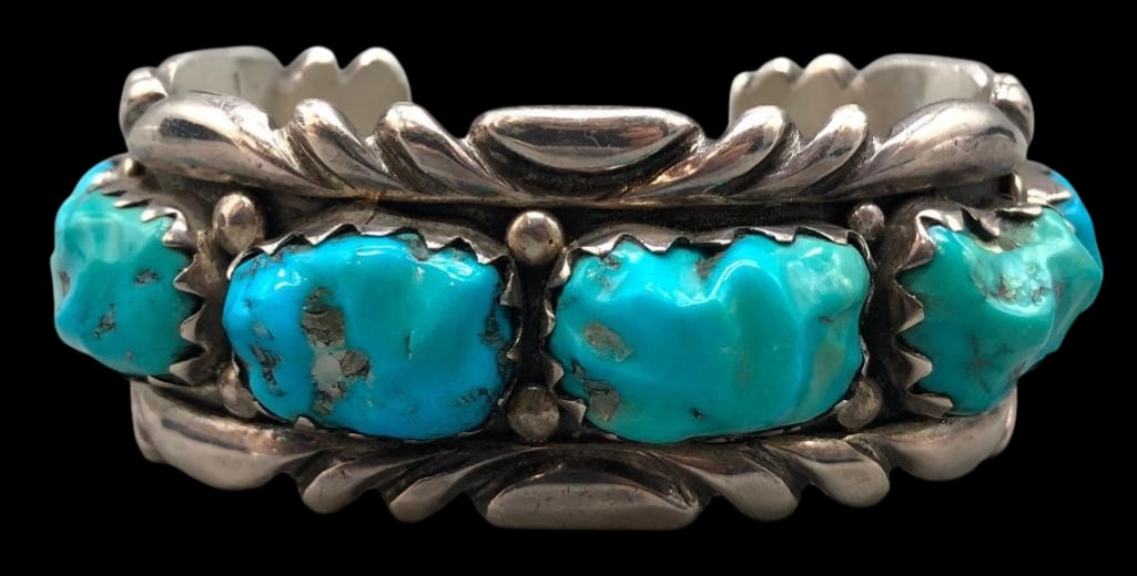 Heavy Sterling Silver And Turquoise Cuff Bracelet By Shirley Quam: For your bidding enjoyment we present a heavy sterling and turquoise cuff bracelet by Shirley Quam. This bracelet features eight carved turquoise cabochons set in sawtooth silver bezels. The stones ar
