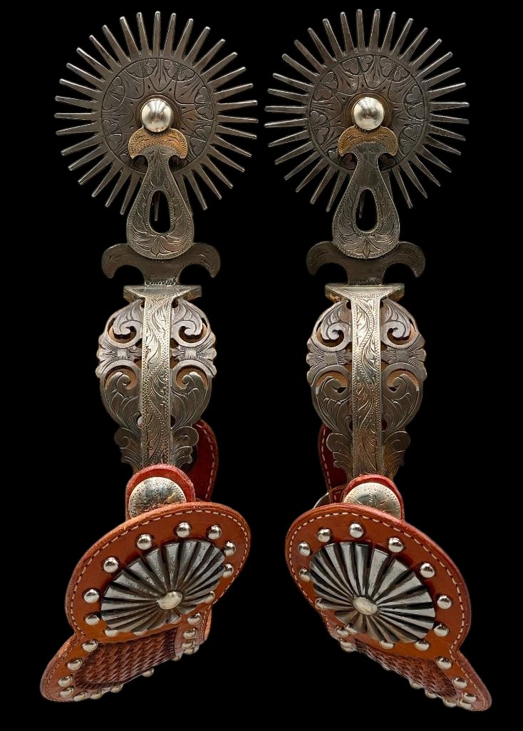 L&M Spurs With L&M Conchos And Spur Straps: Offered here is a great pair of L&M spurs with L&M conchos and spur straps. These double mounted spurs feature floral engraved silver work from the heel band through the shank. They are finish