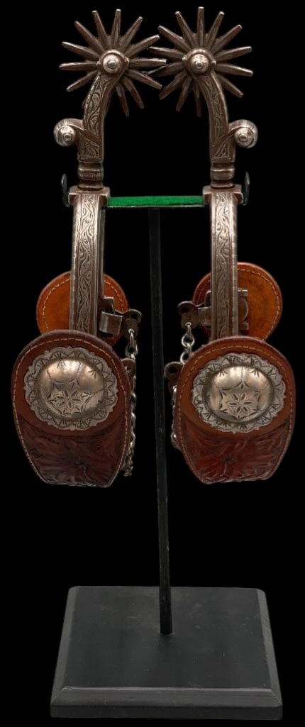 Antique Visalia Stock Saddle Company Spurs With Straps And Stand: Available here for your consideration is a great pair of antique Visalia Stock Saddle Company spurs with straps and stand. These single mounted spurs feature engraved silver work on the heels and shan