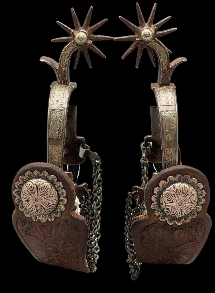 Antique Pair of California Style Spurs With Straps: Offered here for your consideration is an antique pair of California style spurs with spur straps. These single mounted spurs feature engraved silver work on the heel bands and shanks. The spurs are f