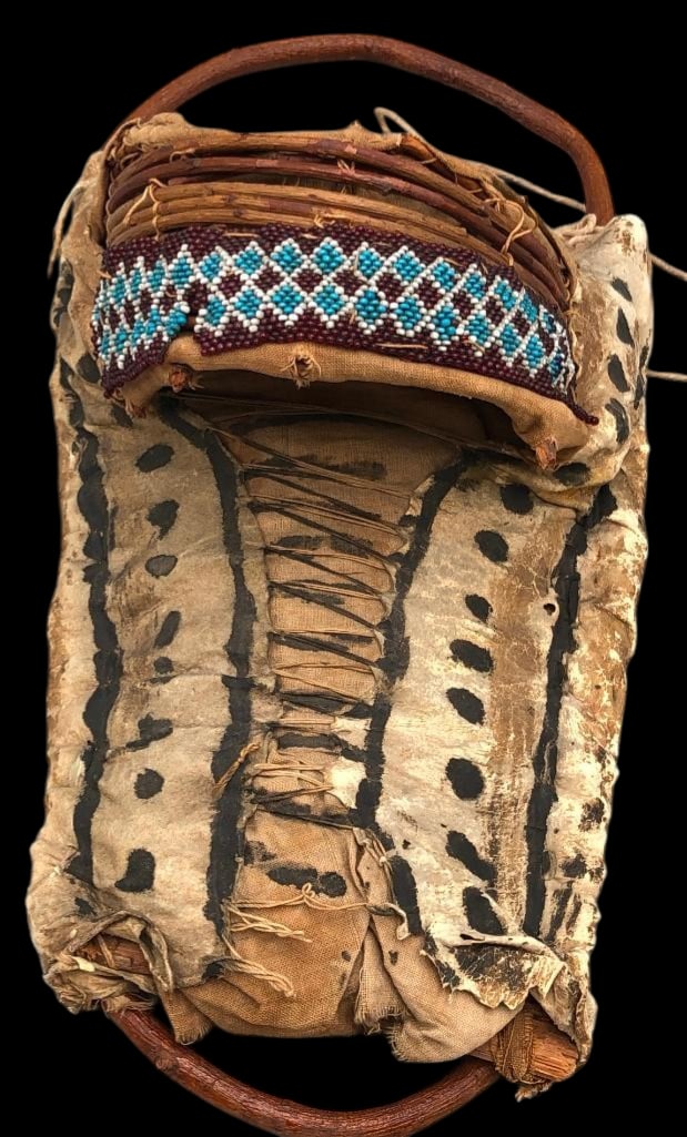 Early Apache Doll Size Cradle Board: Available here for your consideration is an early Apache, doll size cradle board. This piece is a brain tanned leather body highlighted with black painted linear and dotted designs. The frame and hood