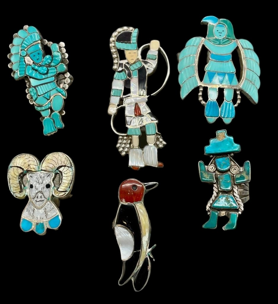 Six Zuni Figural Inlay Rings: Offered here are siz Zuni figural inlay rings. Each ring showcases a different design, incorporating channel inlay, multi stone inlay, or intricately carved turquoise inlay. The imagery varies from pi
