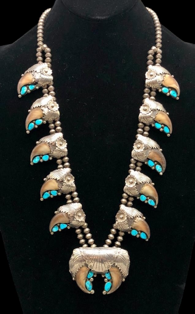 Sterling Silver Turquoise And Claw Squash Blossom Necklace Style: Offered here for your consideration is a sterling silver turquoise and claw squash blossom necklace style. The naja showcases four turquoise cabochons set in sawtooth silver bezels. Accenting the ston