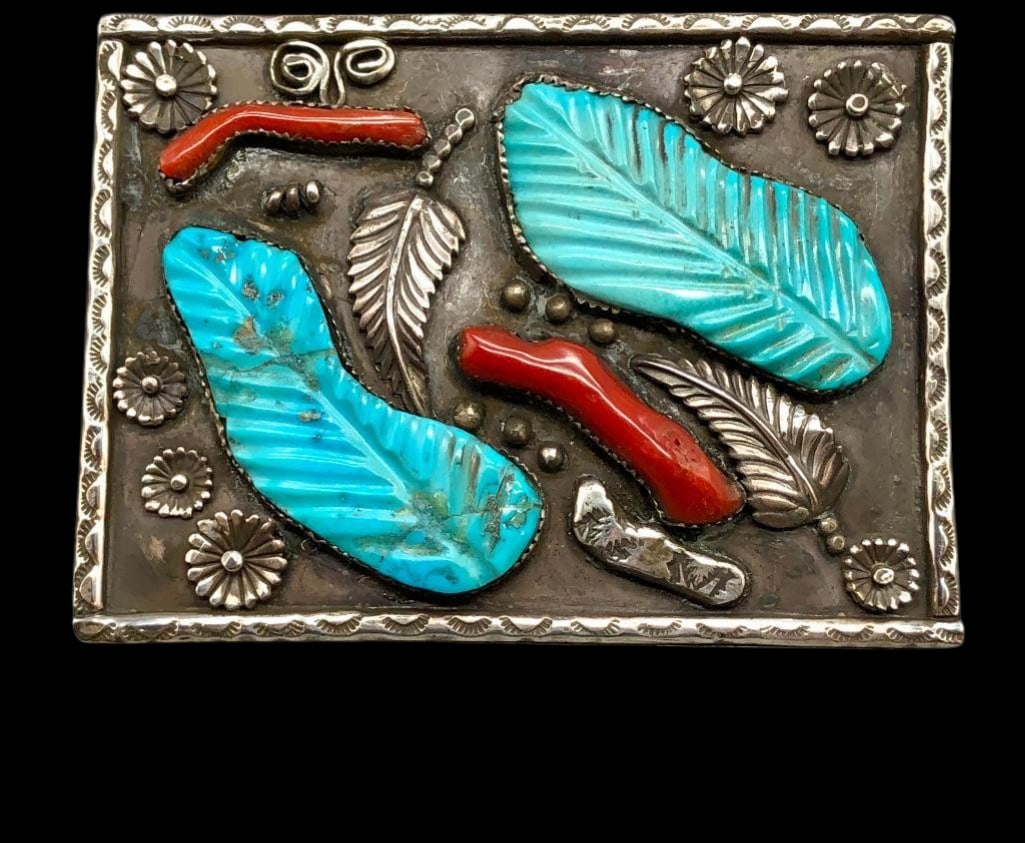 Zuni Sterling Silver, Coral And Carved Turquoise Belt Buckle: Available here in this lot is a Zuni sterling silver, coral and carved turquoise belt buckle. The piece is highlighted with two branch coral cabochons and two turquoise cabochons with carved leaf desi