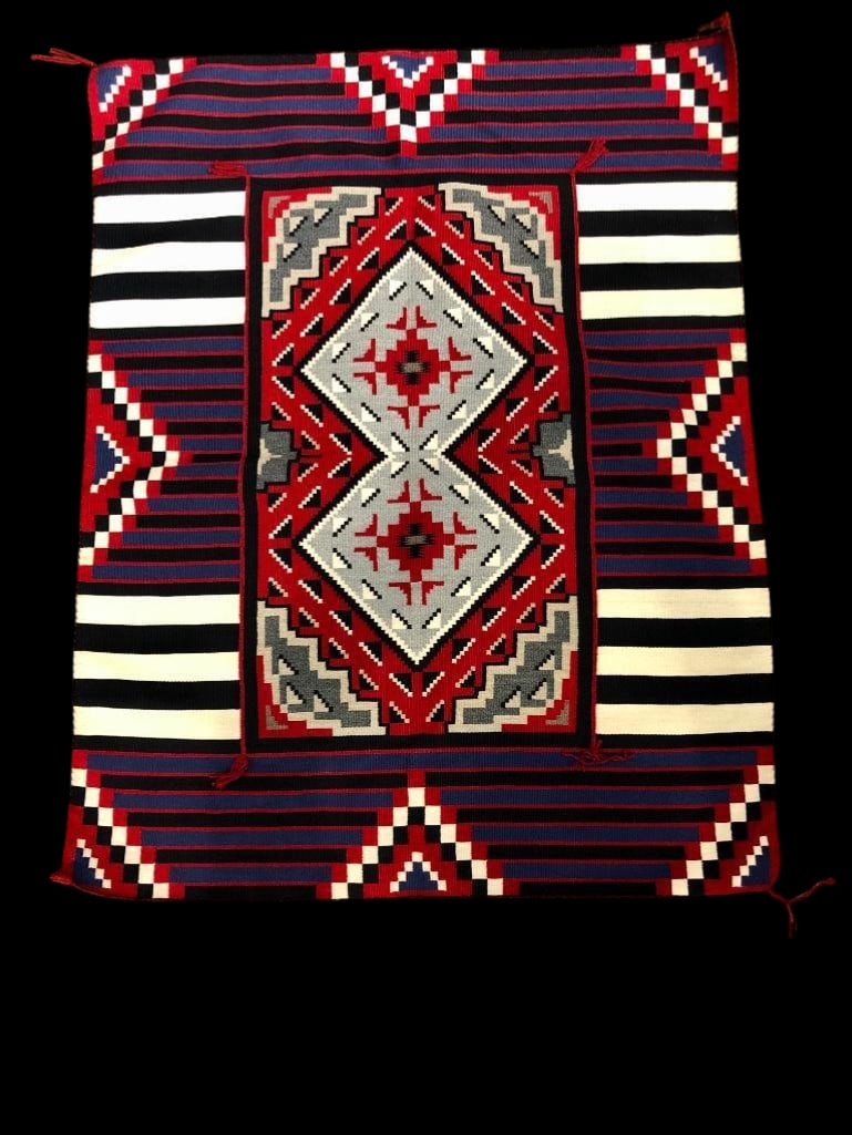 Fine Two in One Design Navajo Textile By Ruby Hubbard: Offered here for your consideration is a fine Two in One design Navajo textile by Ruby Hubbard. This weaving features a Ganado style weaving with tassels centered in a Third Phase Chief Blanket design