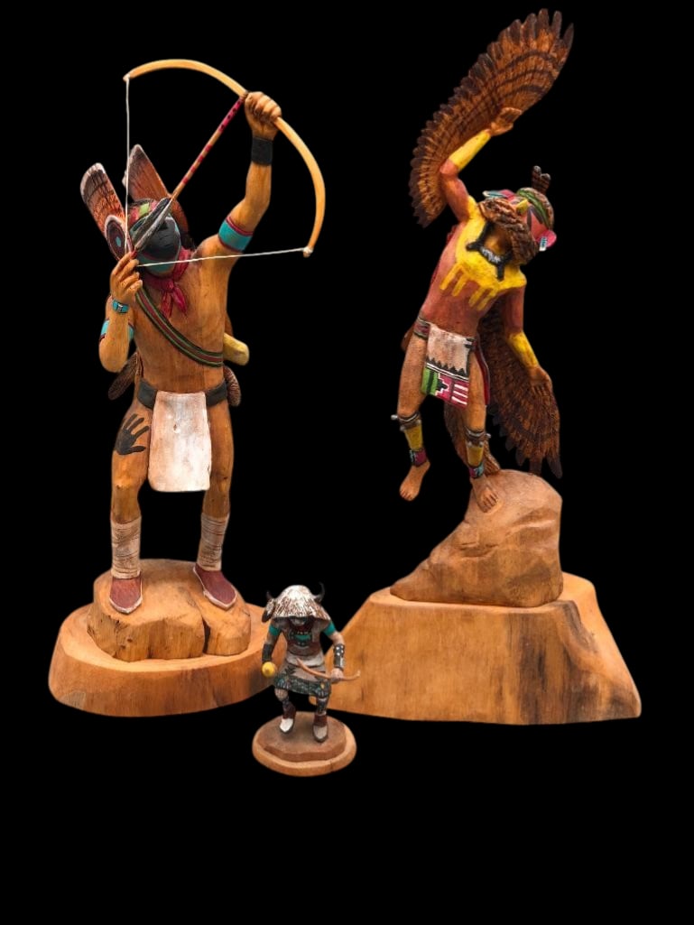 Group Of Three Kachinas By Raymond And Duwayne Chee: Offered here for your consideration is a group of three carved Kachinas by Raymond and Duwayne Chee. This lot includes two larger figures on carved wood bases and one smaller figure on a round base. T