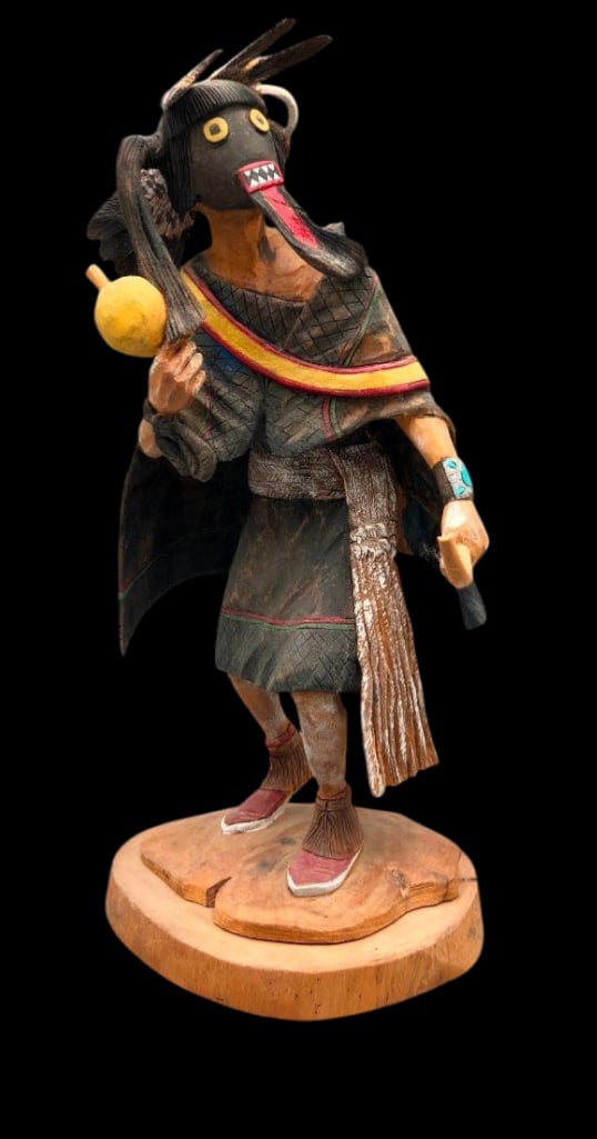 Warrior Maiden Kachina By Raymond M. Chee: Offered here for your consideration is a carved figure titled “Warrior Maiden” Kachina by Raymond M. Chee. The carving features a figure holding a rattle and a bow wearing moccasins, a manta,
