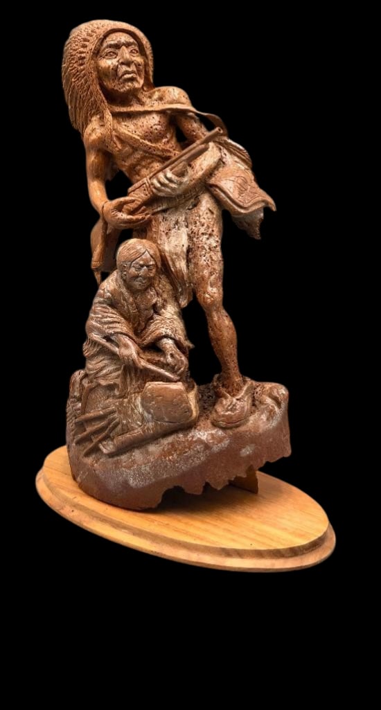 Mammoth Bone Sioux Warrior Carving: Offered here for your consideration is a mammoth bone Sioux warrior carving. This piece depicts a Sioux warrior figure wearing a traditional feather headdress and equipped with a rifle. Below him is a