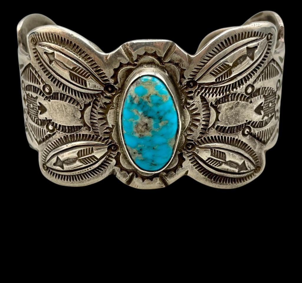 Intricate Ingot Silver And Turquoise Bracelet: Offered here for your consideration is an intricate ingot silver and turquoise bracelet. This bracelet features an oval turquoise cabochon set in a smooth silver bezel. Accenting the stone are repouss