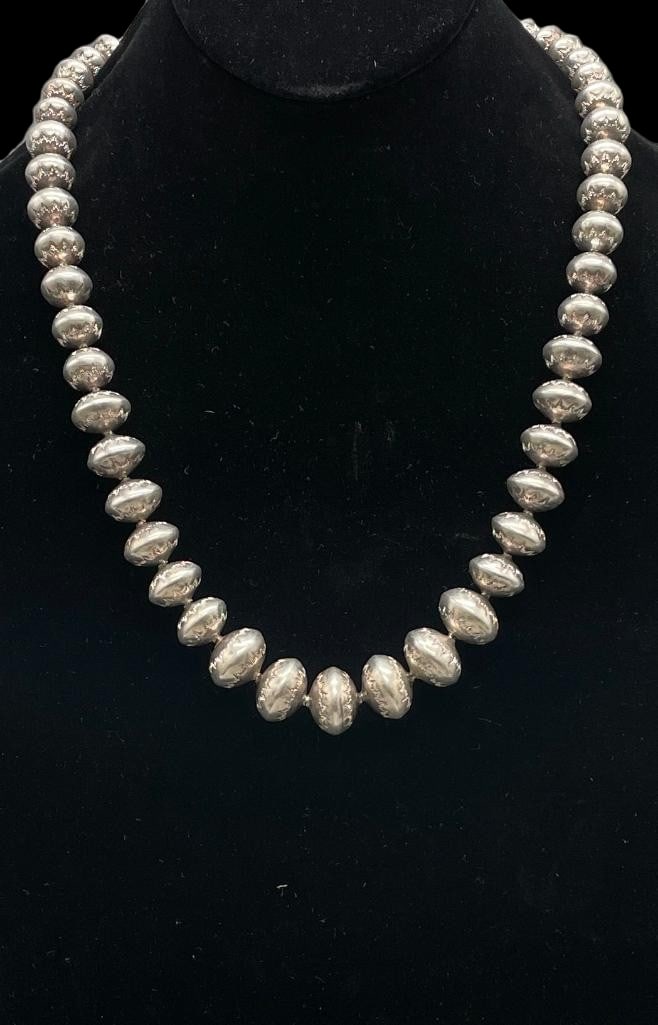 Stamped Sterling Silver Graduated Bead Necklace: Offered here for your consideration is a stamped sterling silver graduated bead necklace. This piece features handmade sterling silver beads in graduated sizes highlighted with hand stamped designs, s
