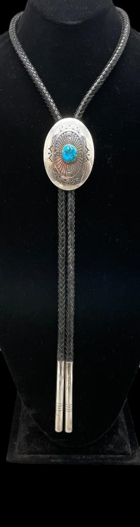 Sterling Silver And Turquoise Bolo Tie By Robert Bobby Johnson: Offered for your consideration is a sterling silver and turquoise bolo tie by Robert "Bobby" Johnson. This slide is sterling silver in an oval shape with a turquoise cabochon set in a smooth s