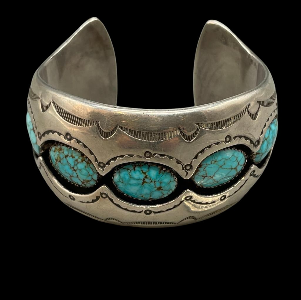 Number 8 Turquoise And Sterling Silver Bracelet: For your bidding enjoyment we present a Number 8 Turquoise and Sterling Silver Bracelet. This bracelet features seven #8 turquoise cabochons set in smooth silver bezels surrounded by shadow box design