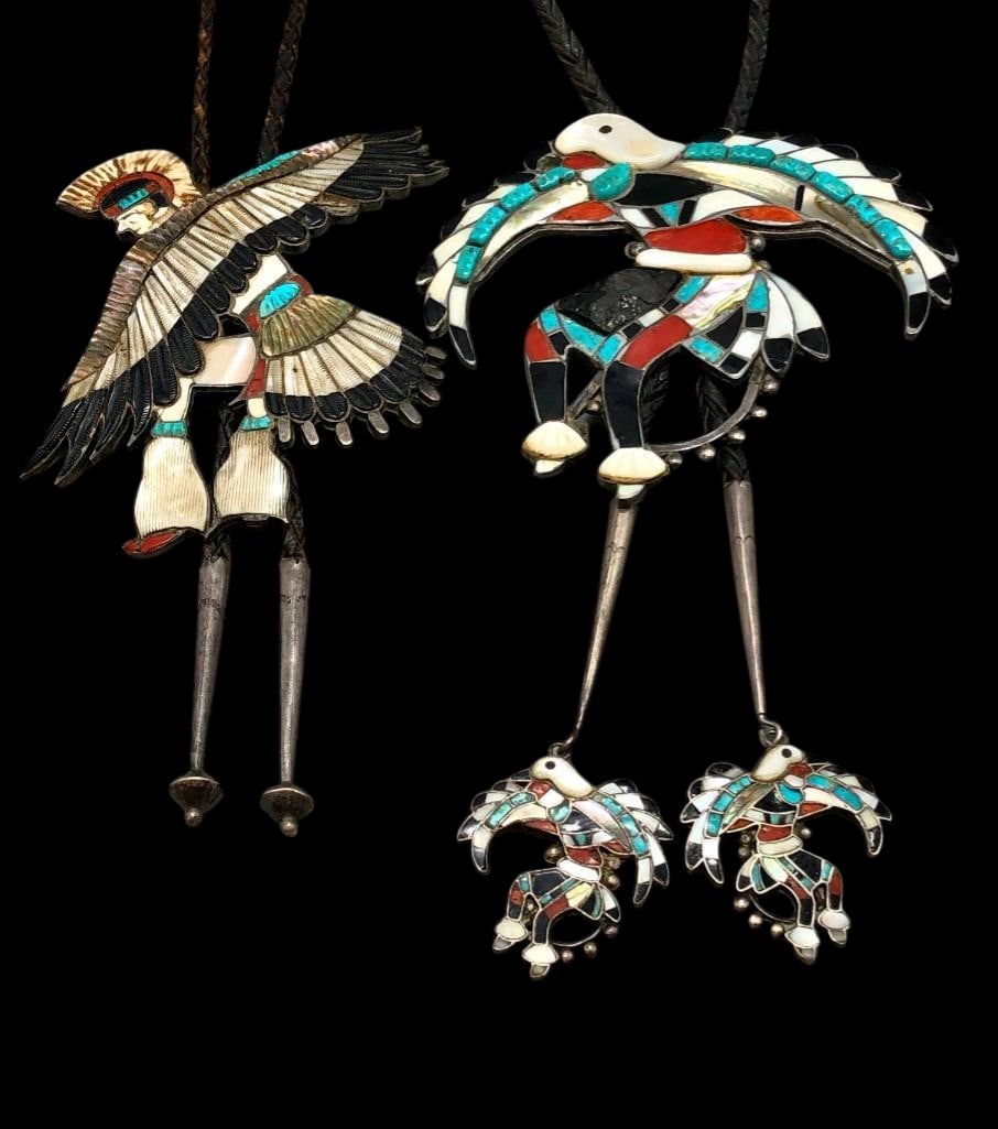 Two Eagle Dancer Themed Zuni Inlay Bolo Ties Circa 1960s -1970s: Offered for your consideration is two Eagle Dancer themed Zuni inlay bolo ties circa 1960s. These are handcrafted intricate bolo ties forming Eagle Dancer designs. Both slides contain coral, mother of
