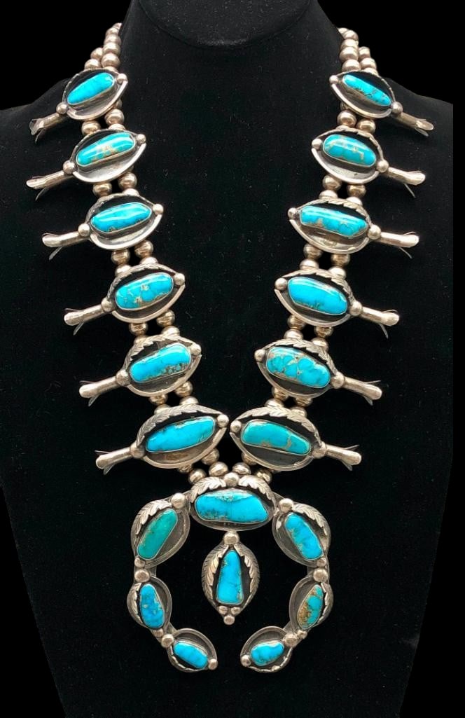 Statement Vintage Turquoise Squash Blossom Necklace: Offered here for your consideration is a statement type of vintage turquoise squash blossom necklace. The naja features a classic crescent shape, while the neckline is decorated with 14 matching tab s