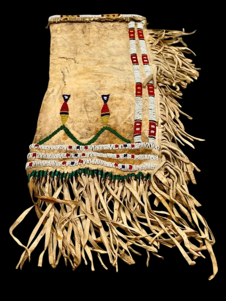 Vintage Circa 1950s Plains Beaded Pipe Bag: Offered here for your consideration is a vintage circa 1950s Plains beaded pipe bag. This pieces features beadwork with geometric designs done in colors red, white, green and others. The beads are sew