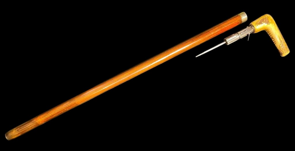 Antique Cane Revolver/Dagger: Offered here for your consideration is an antique cane with revolver/dagger hidden inside. This piece features an antler style handle and wood cane shaft. The handle section removes from the shaft and