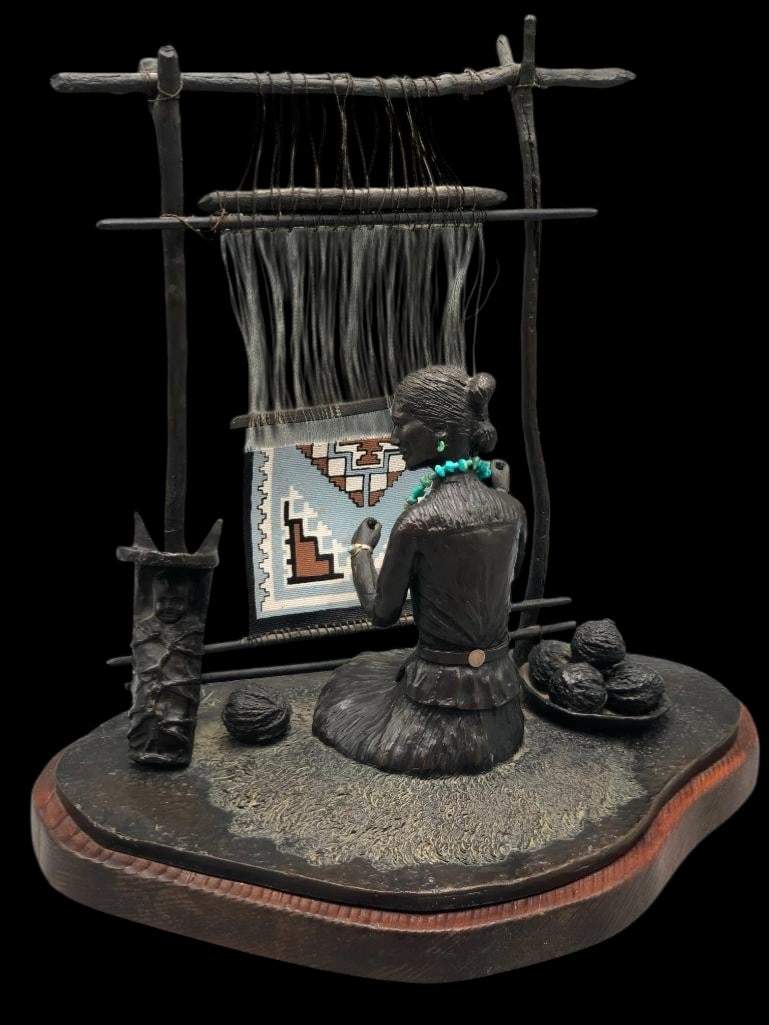 Happy Day - A Bronze By L. Tidd 14 of 16 - 1976: Offered here for your consideration is "Happy Day" a bronze statue by L. Tidd numbered 14 of 16 from 1976. This piece depicts a seated Navajo woman at a loom weaving a rug design. She is furth