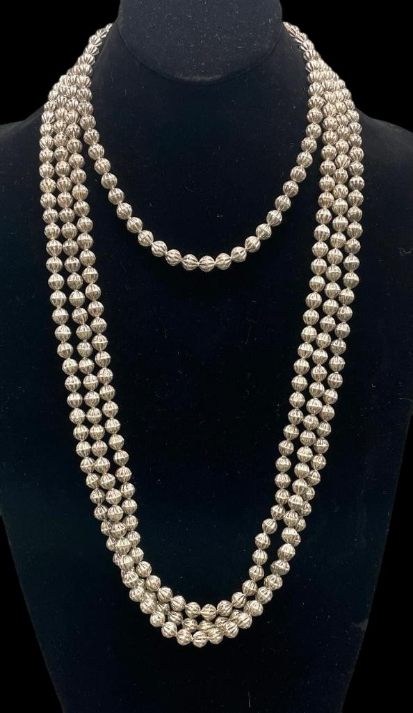 Four Strands Of Fluted Sterling Silver Beads: Offered here for your consideration are four strands of fluted sterling silver beads. Each piece features a strand of round fluted silver beads strung on a cord. These are perfect for stacking or addi