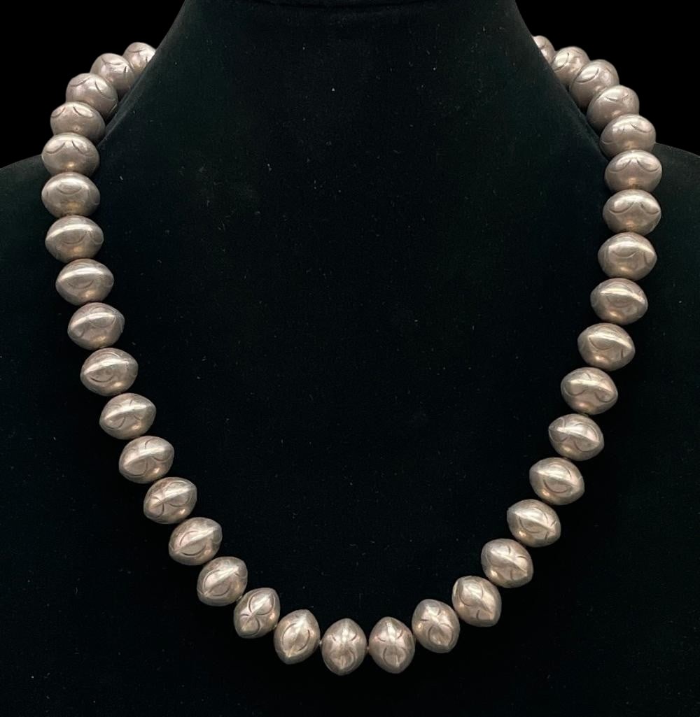 Circa 1970s-1980s Sterling Silver Stamped Bead Necklace: Offered here for your consideration is a circa 1970s-1980s sterling silver stamped bead necklace. This piece features round silver beads accented with hand stamped designs. The beads are strung on fox