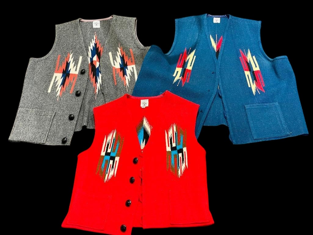 Three Vintage Chimayo Handmade Vests: Offered here for your consideration are three Chimayo handmade vests. The first one is red with geometric patterns on the front and back. The front is accented with four buttons and two lined pockets.