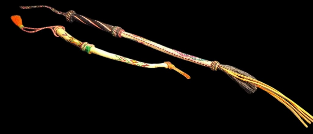 Two Deerlodge Hitched Horsehair Quirts: Offered here for your consideration are two Deer Lodge hitched horsehair quirts. Both feature hitched horsehair designs done in colors of green, pink, yellow and others. They have wrist thongs on the 