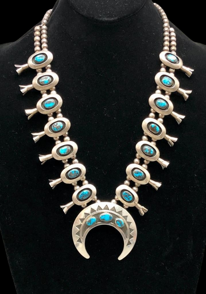 Bisbee Turquoise And Sterling Silver Squash Blossom Necklace With Four Petal Blossoms: Offered here for your consideration is a Bisbee turquoise and sterling silver squash blossom necklace with four petal blossoms. This necklace features a naja highlighted with three Bisbee turquoise ca