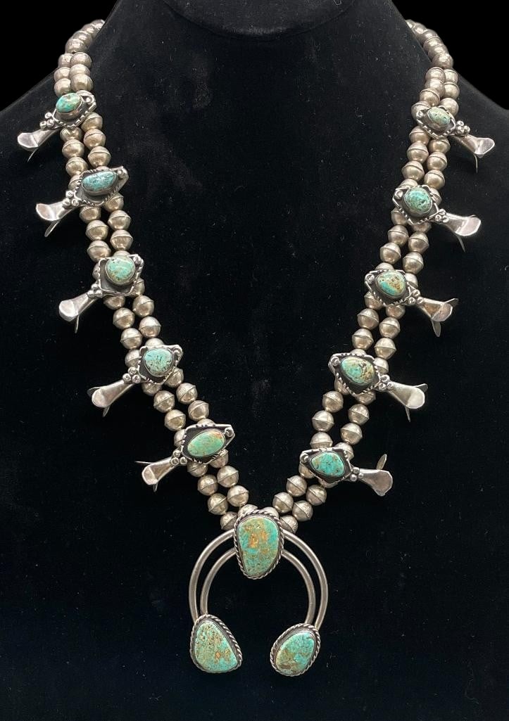 Green Turquoise And Sterling Silver Squash Blossom Necklace: Offered here for your consideration is a green turquoise and sterling silver squash blossom necklace. The two wire naja features three green turquoise cabochons set in smooth silver bezels accented wi