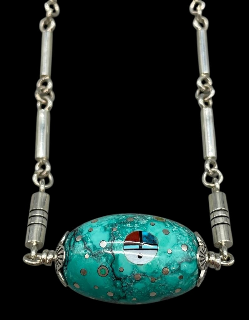 Large Turquoise Bead With Inlay On Sterling Silver Chain By Ernest Begay: Offered here for your consideration is a large turquoise bead with inlay on a sterling silver chain by Ernest Benally. This piece features a large turquoise bead pendant highlighted with a multi stone